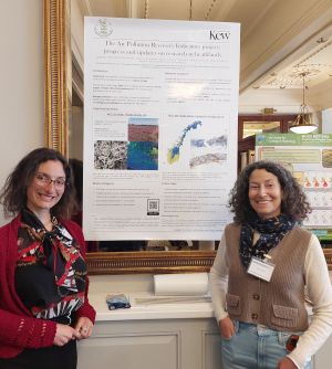 ©Kew two people standing either side of a poster